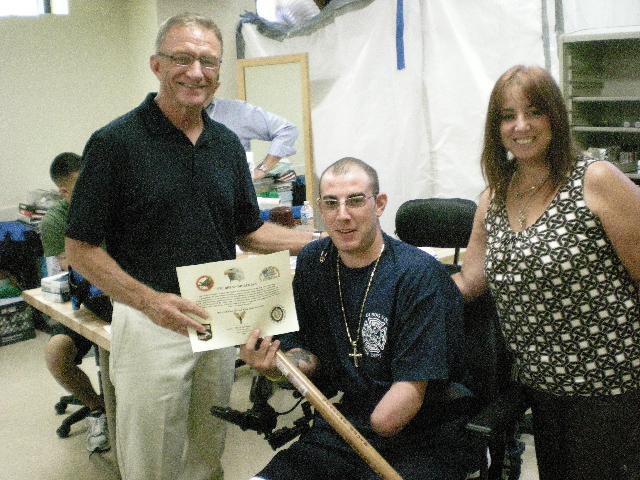 Army PFC Bryan Dilberian & wife. Cane presented by Harry Monahn, USMC Ret. (left). Cane carved by Hal Weisel of HVWC.