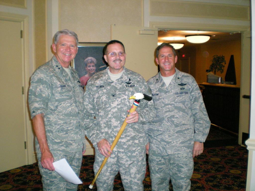 Army COL Russell Zelman presented by General Ickes and General Golfein. Cane carved by Pat Paraggio.
