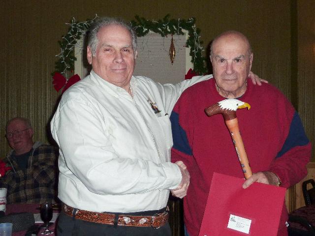 Navy Earnest A Arico. Cane carved by Gerry Hoernes of HVWC. Presented by Pat Paraggio (left) of HVWC.