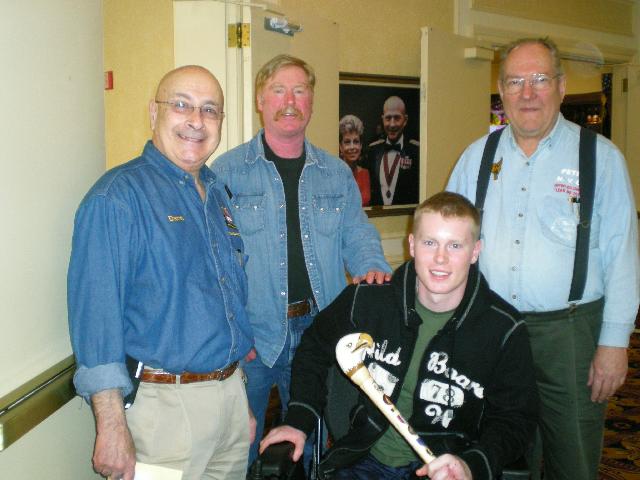 Presentation to LCPL John Curtin by Col Dave Brog RRR (left), Mr Peter Ward NVCA (right), Justins Dad (center). Cane carved by Joe Gleeson of HVWC.