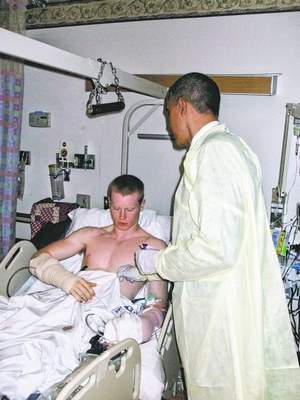 President Barack Obama awards Lance Cpl. John G. Curtin the Purple Heart in a Feb. 23 ceremony at the National Naval Medical Center in Maryland. Curtin, 20, a Wingdale native, lost both legs at the knee in an IED explosion in Afghanistan. / Courtesy photo