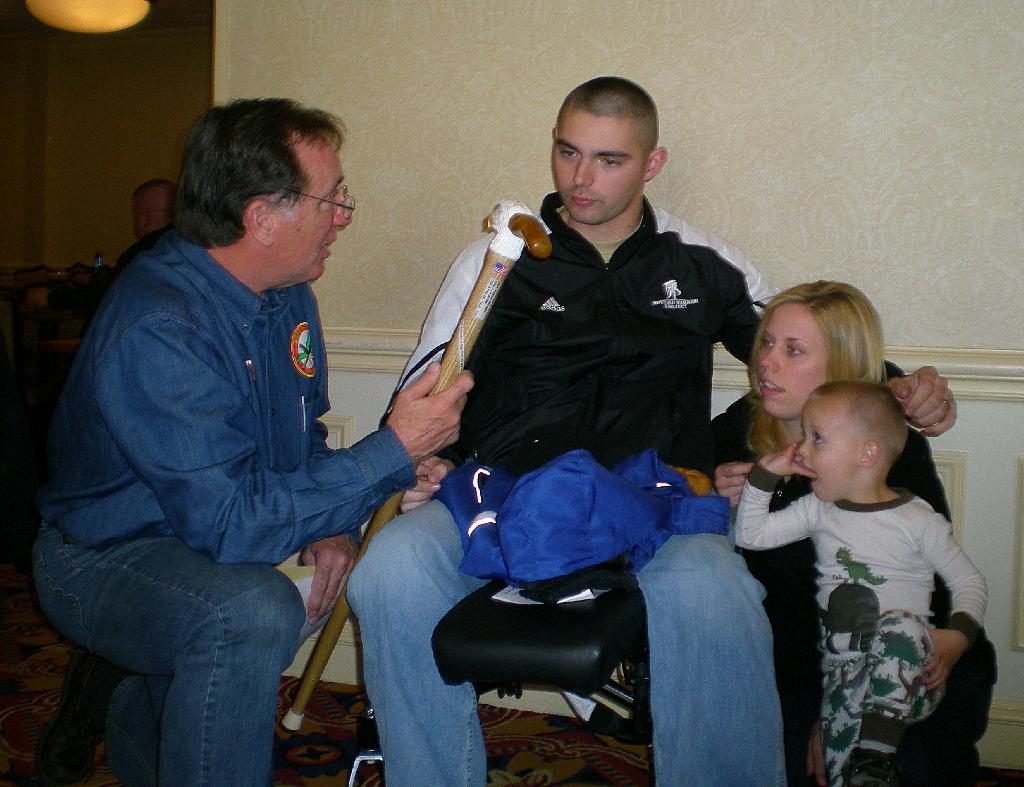 Army SGT Patrick Marziale, with wife and son. Cane presented by COL Mike Conners. Carved by Mike Febbie MVA&WA.