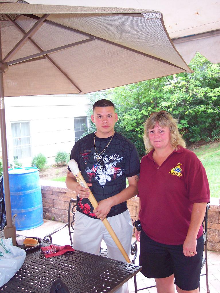 Army SPC Patrick Ruiz with Ann Nettles . Cane carved by Sal Filiponeof HVWC.