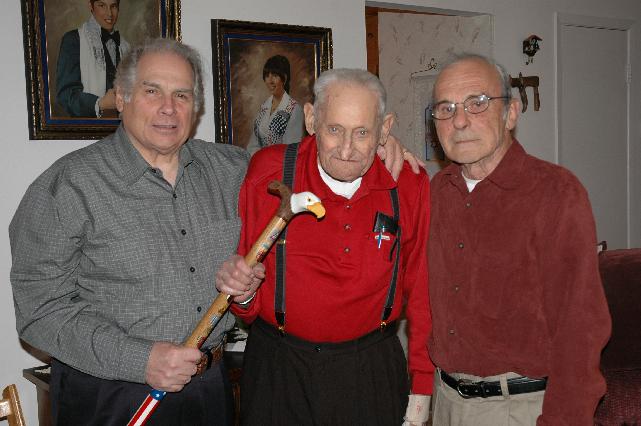 Pat Paraggio on left & Clay Brooks on right of HVWC presenting cane to Army PFC Sidney Davis, WWII Veteran. Cane carved by Hal Weise of HVWC.